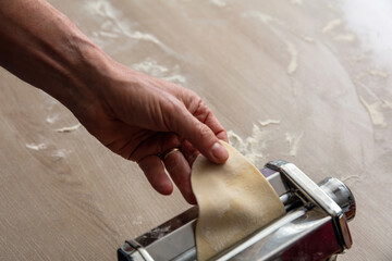 Fresh pasta maker machine. Dough homemade preparation. Hand make dough phylo close up view