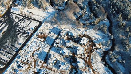 Sports and recreation concept. Motion. Aerial view of the winter cottages construction on the...