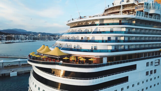 Large Cruise ship sailing across sea near the harbor. Stock. Top view of a huge cruise ship in the sea. Summer vacation concept, travel by water around the world