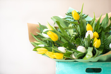 Turquoise rustic box with a bouquet of yellow and white tulips