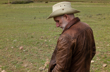 Portrait of adult man in cowboy hat on field