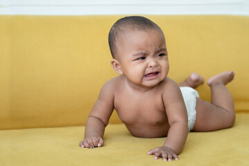 Portrait of Little African newborn baby girl wear diaper crying and tears drop from her eye while...