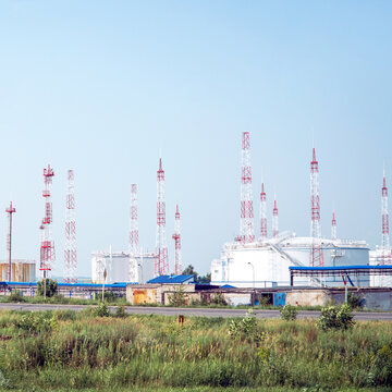 Oil depot on the background of the sky with a lot of lightning rods