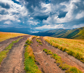 Fototapeta na wymiar Dramatic summer scene of Svydovets mountain range with old country road. Exciting morning view of Carpathian mountains before the storm, Ukraine, Europe. Traveling concept background.