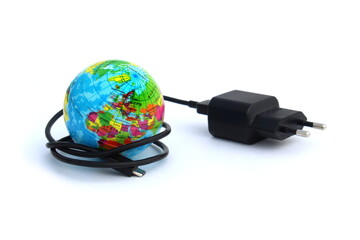 The charging cord is wrapped around a mock-up earth on a white background.