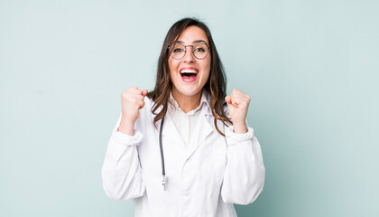 young pretty woman  feeling shocked,laughing and celebrating success. physician concept