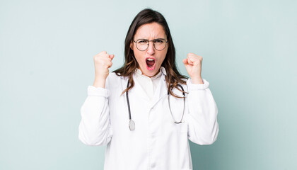 young pretty woman  shouting aggressively with an angry expression. physician concept