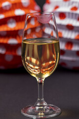Glass of fine wine with woman's lip mark and lanterns. Seville Fair, April Fair.