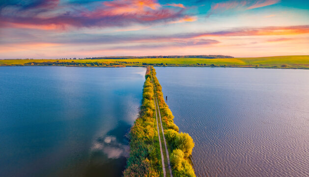 Superb summer sunrise on Vertelka lake, Ternopil region. Spectacular morning view from flying drone of Ukrainian countryside. Traveling concept background.
