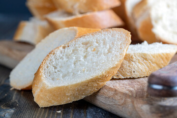 wheat baguette cut into pieces on a cutting board