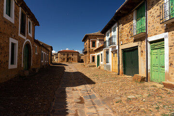 Fototapeta na wymiar Street of Castrillo de los Polvazares village with the typical houses, Astorga, Leon, Spain.