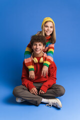 White girl and boy laughing and hugging while posing at camera