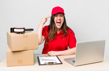 young pretty woman  looking unhappy and stressed, suicide gesture making gun sign. company packer...