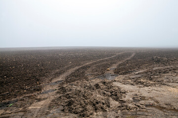 ruts on the road for cars in the field in autumn after rains