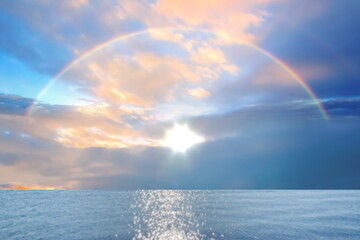 Rainbow at sea   blue sky with pink clouds and turquoise sky  pastel color  summer beach holiday