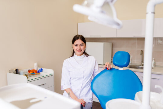 Portrait of female dentist .She standing in her dentist office.