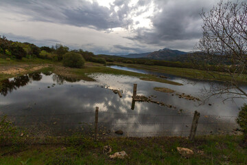 Long shot of a lake with mountains