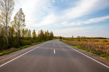 Fototapeta premium an empty paved road in the countryside