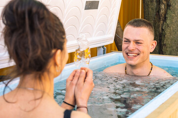 Couple having fun, smiling and bathing in the cold water among ice cubes. Wim Hof Method, cold...