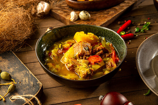 Portion of georgian buglama lamb dish on wooden background