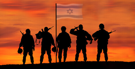 Fototapeta na wymiar Silhouette of Soldier in sunset background . Flag of Israel. National holiday .