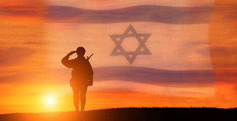 Silhouette of Soldier in sunset background . Flag of Israel. National holiday .