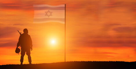 Silhouette of Soldier in sunset background . Flag of Israel. National holiday .
