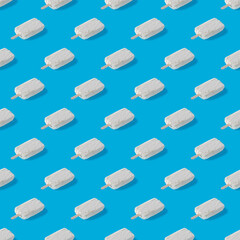 Repeating pattern of white creamy ice cream on a blue background