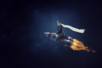 Obraz na płótnie Canvas Businessman on a rocket . Mixed media