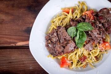 Grilled flank steak over basil pesto keto pasta