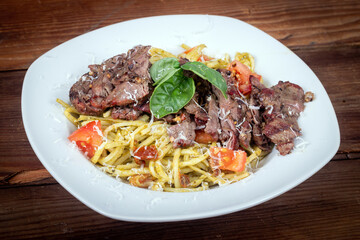 Grilled flank steak over basil pesto keto pasta