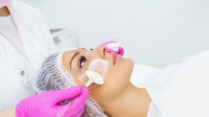  Woman receiving facial mask at beauty salon
