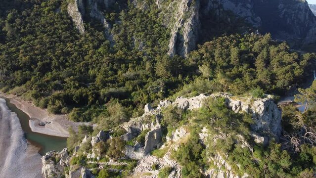 Sunny day, aerial view, flyby of points of interest, Mount Olympus, Olympus village, Turkey, Lycian Trail. Aerial drone of Cirali beach and Olympos Olimpos mountain in a beautiful day light. Kemer