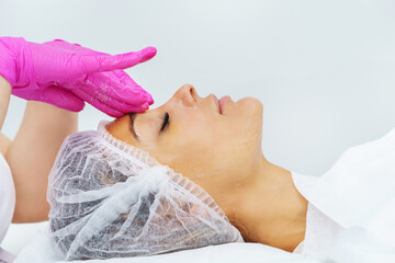  Beautiful woman in professional beauty salon during photo rejuvenation procedure