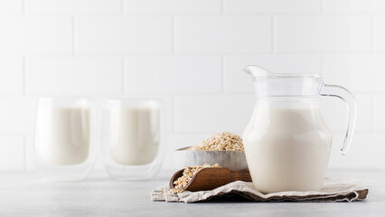 Vegan oat milk, non-dairy alternative milk in a jug. Vegan non-dairy alternative milk. Copy space.