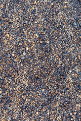 Crushed stone on the seashore. Selective focus on object. The stones were laid on the ground in the garden as a background. Background blur. Pebble stones background.