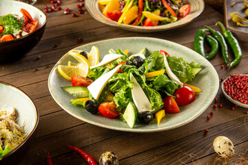 Portion of fresh greek salad on wooden table