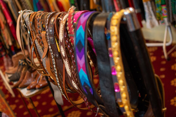 Vintage fashion belts on dress rail