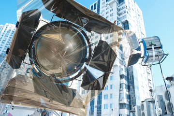 Spotlight on the set. professional lighting device for filming a movie or advertising. blue background 