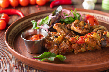 Turkey skewers, vegetable salsa and barbecue sauce on wooden background, restaurant dish, Closeup