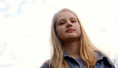 portrait of a young teenage girl of European appearance selective focus close-up, children's emotions