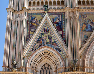 Detail of the facade famous cathedral Santa Maria Assunta made of mosaic scenes from the bible about the central square of the old city Orvieto, Duomo di Orvieto , Umbria, Italy ,Terni province