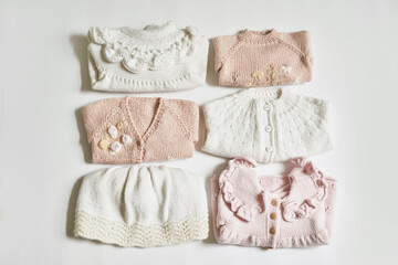 Stack of knitted clothes. Baby clothes. Needlework, hobby, knitting, handwork