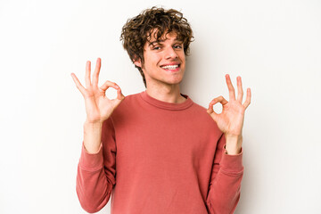 Young caucasian man isolated on white background cheerful and confident showing ok gesture.