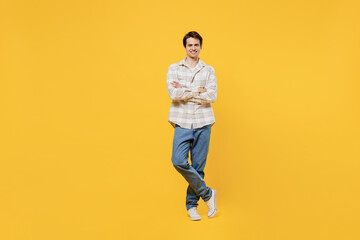 Fototapeta na wymiar Full body young smiling happy cheerful caucasian man 20s wearing white casual shirt hold hands crossed folded look camera isolated on plain yellow background studio portrait. People lifestyle concept.