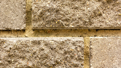 The texture of the wall of light beige brick close-up.
