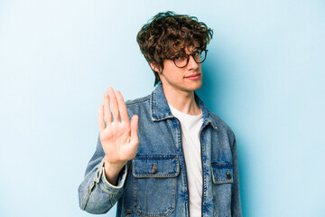 Young caucasian man isolated on blue background rejecting someone showing a gesture of disgust.