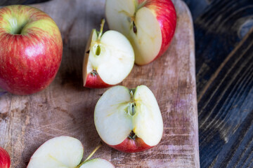 cutting old board with pieces of red ripe apple