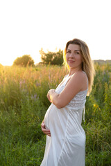 Naklejka na ściany i meble mother to be. pregnancy portrait. beautiful brunette pregnant female expecting child. Happy future mother expecting a baby soon