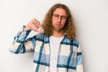 Young caucasian man isolated on white background showing a dislike gesture, thumbs down....